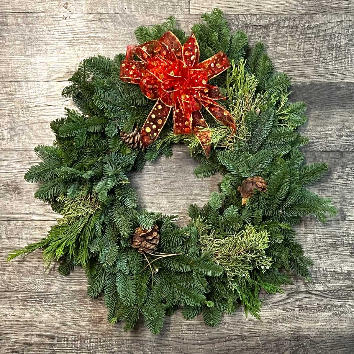 Calallen Christmas wreath with pinecones and red bow