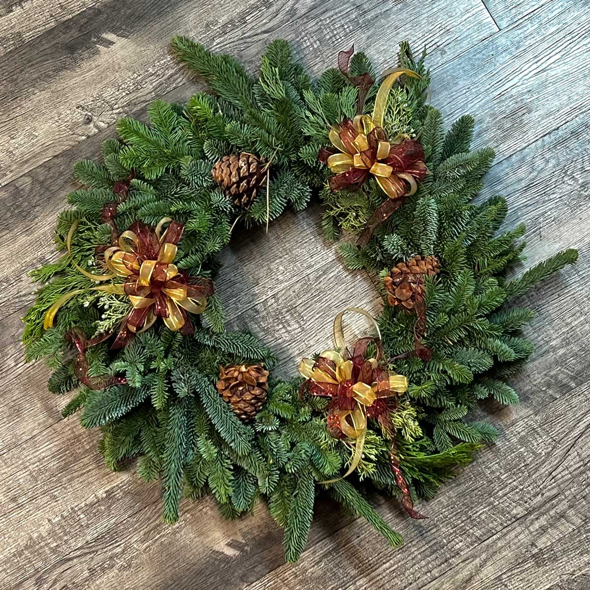 Christmas wreath with pinecones and bows