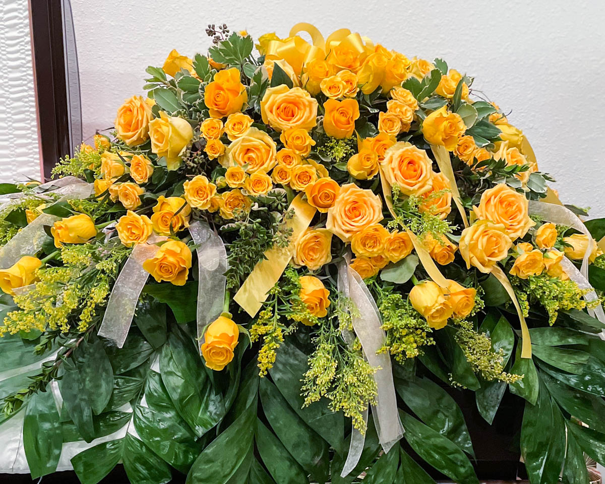 Yellow rose casket cover from Annaville Florist