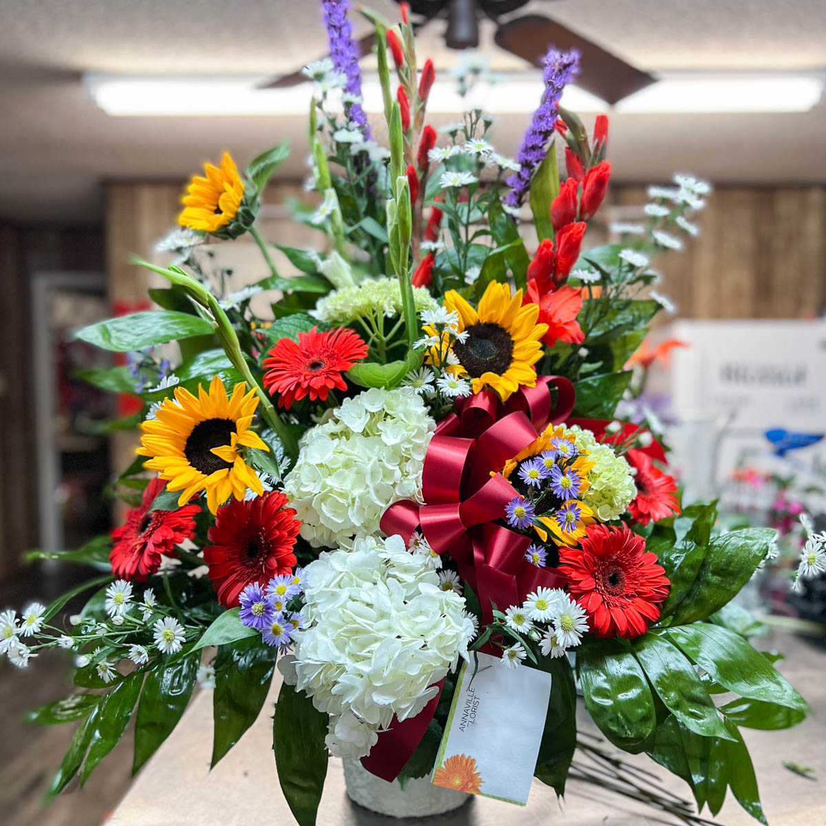 Sunflower mix funeral basket by Annaville Florist