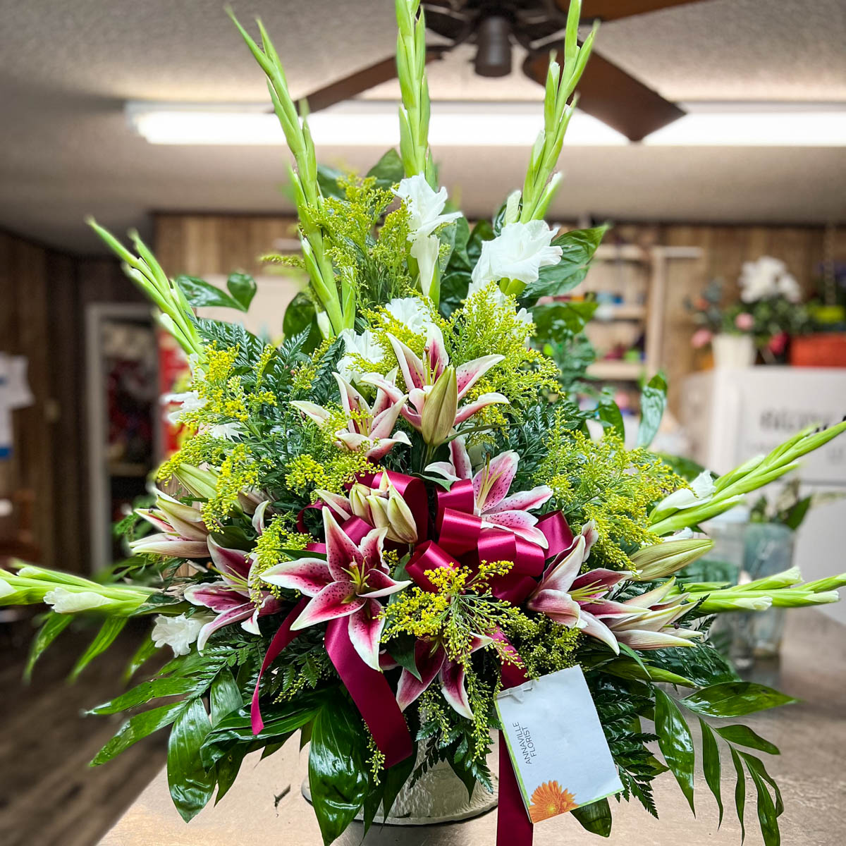 Funeral basket with lilies and gladiolus by Annaville Florist