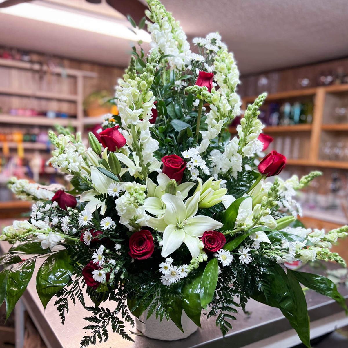 Funeral basket of lilies, roses and stock by Annaville Florist