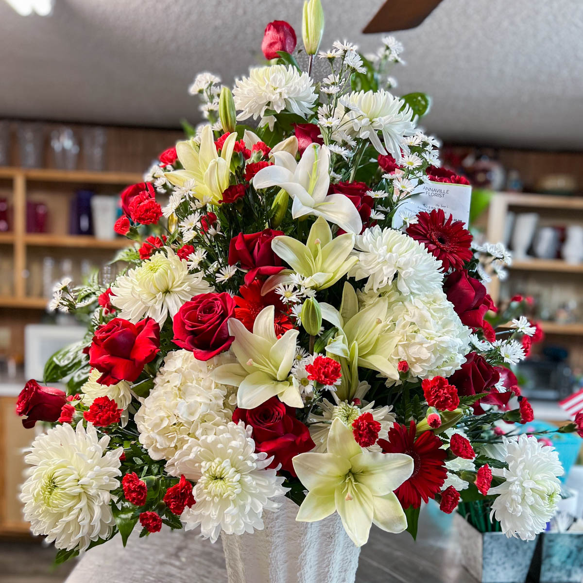Red and White funeral basket by Annaville Florist