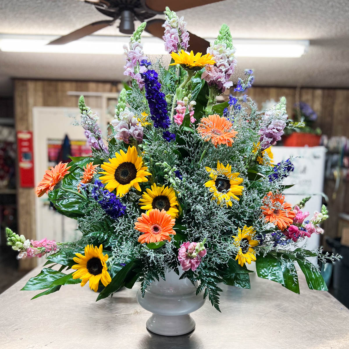 Sunflower spring mix funeral basket by Annaville Florist