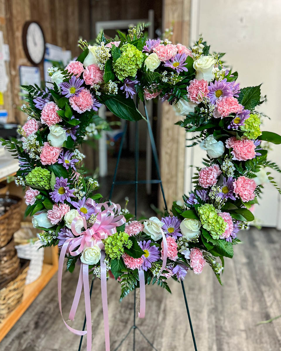 Pastel funeral wreath by Annaville Florist