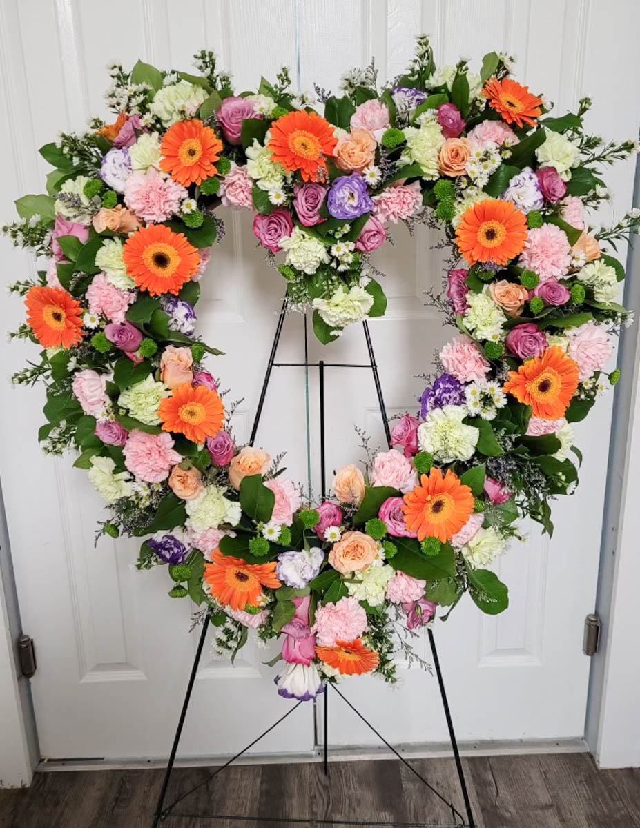 Orange and pink open heart spray from Annaville Florist