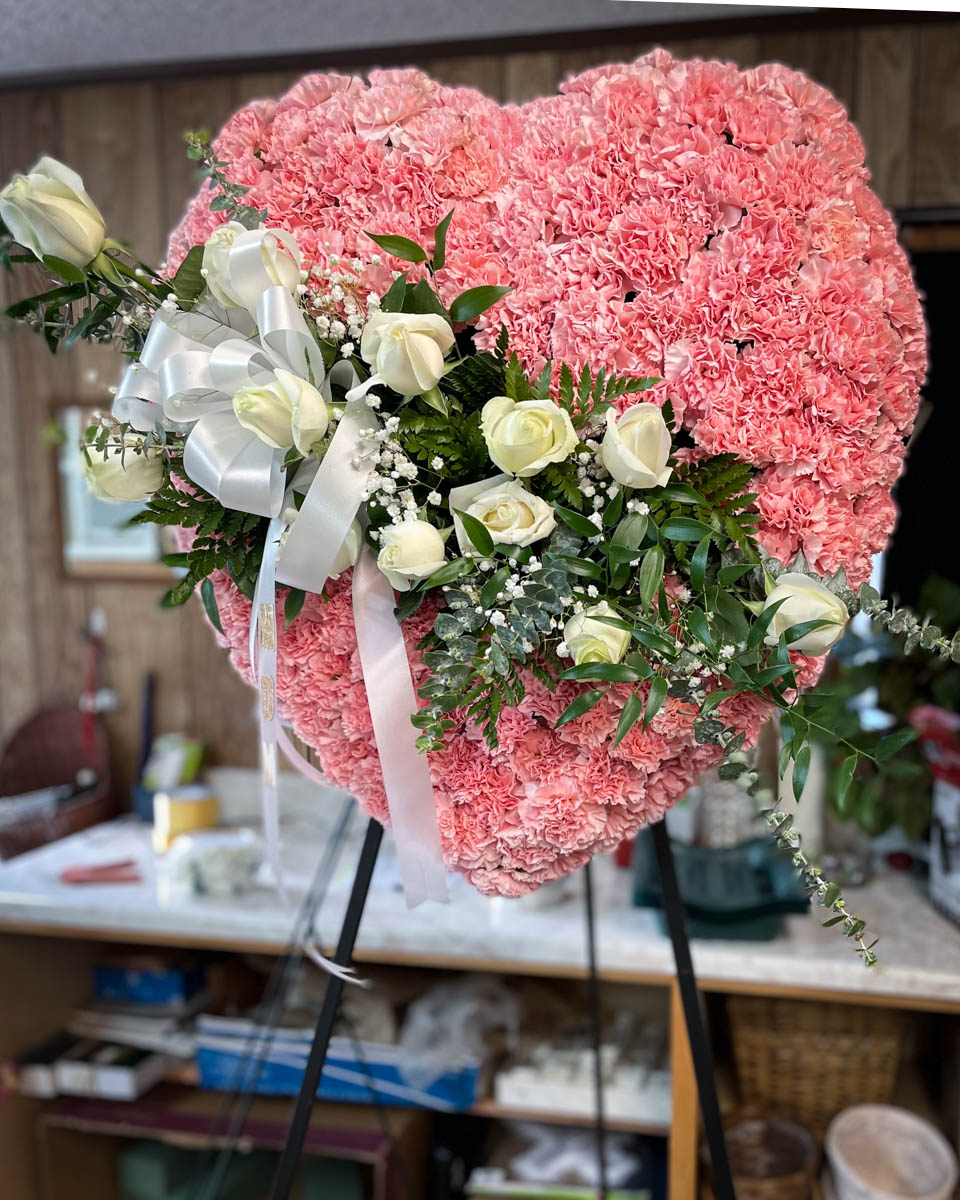 Solid heart pink carnation funeral spray from Annaville Florist
