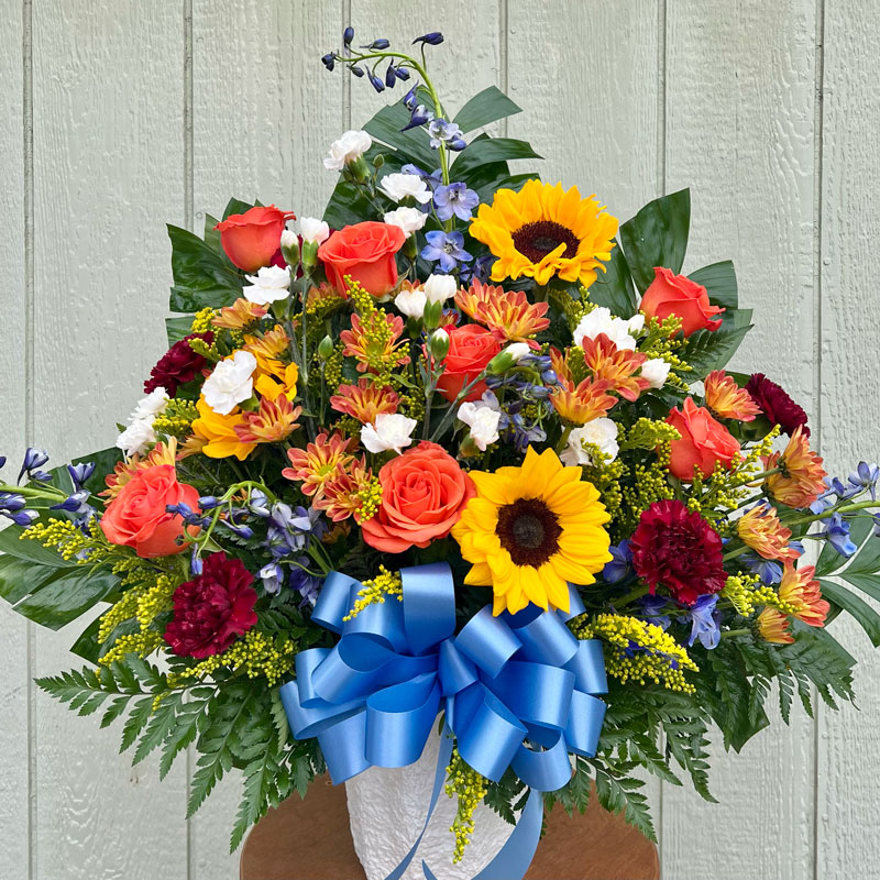 Fall-Colored Funeral Basket with a Blue Bow